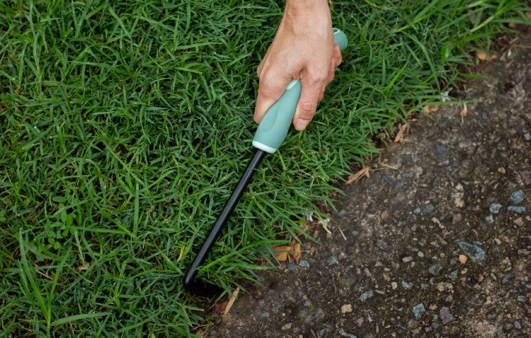 hand scythe weeder tidying up lawn