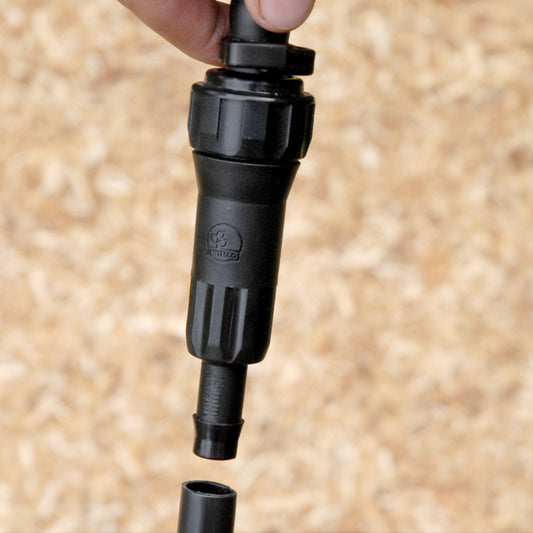 close-up of 13mm in-;ine water filter for irrigation kit being installed into poly pipe
