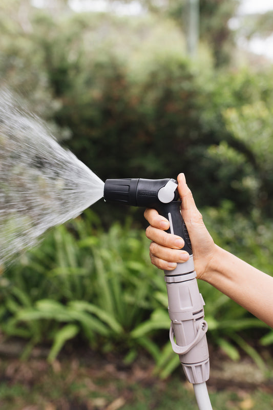 Compact Nozzle Starter Set in use with shower spray setting in garden