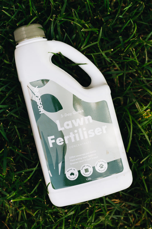 lawn fertiliser bottle laying on grass