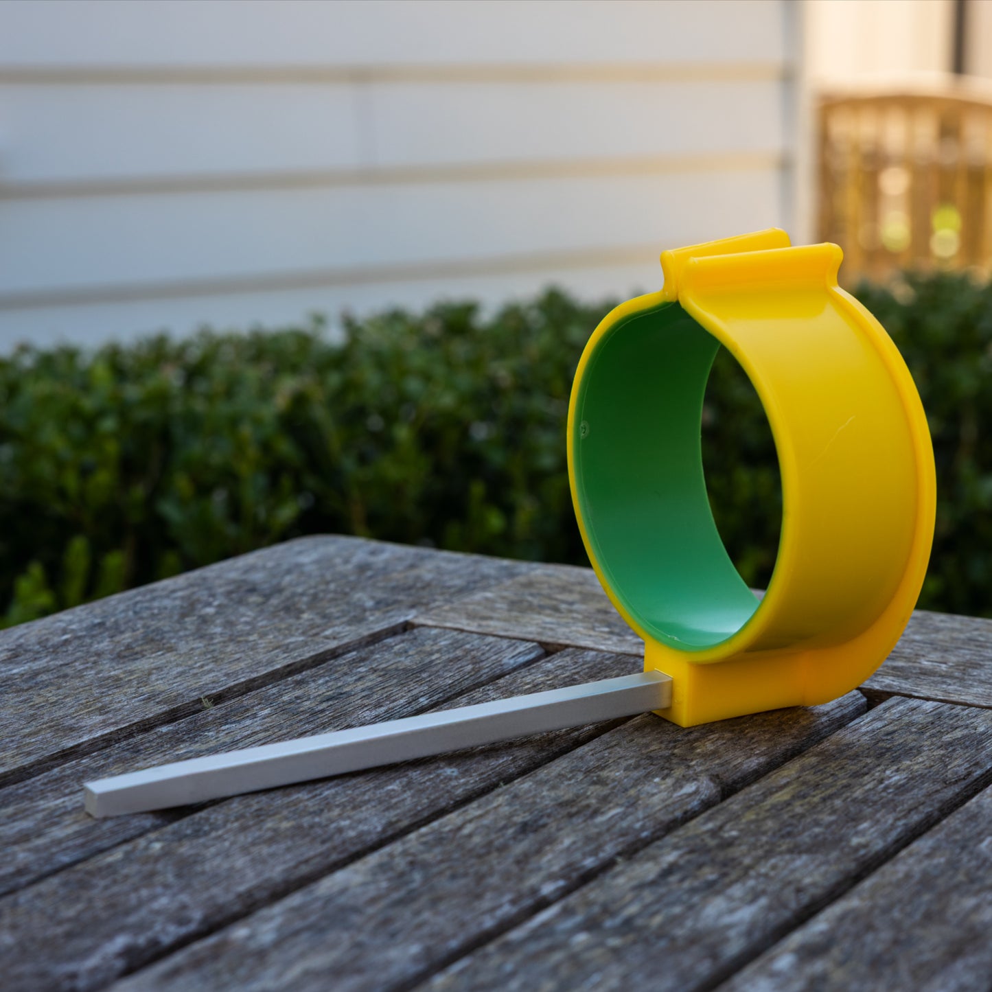 PETA Easi-Grip Arm Support Cuff sitting on a wooden deck by itself