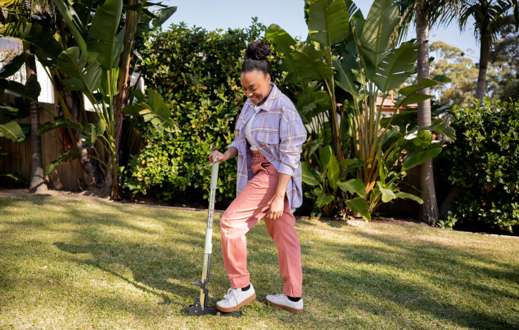 woman using stand up weed puller