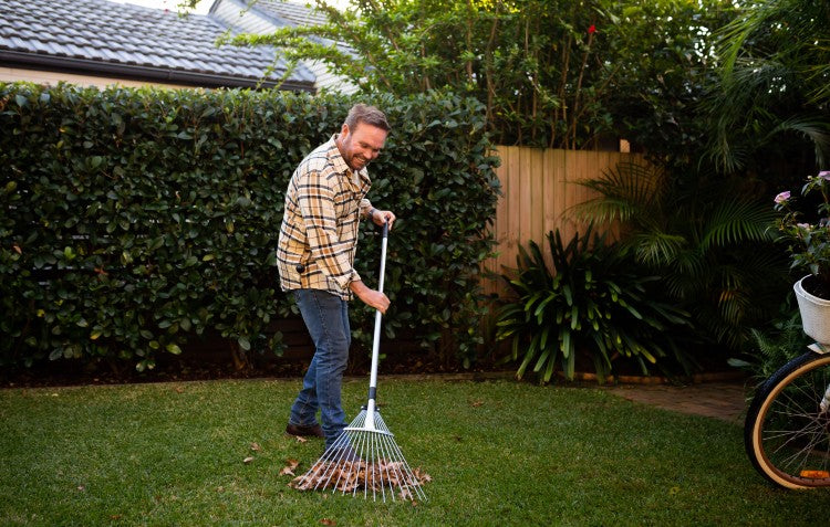 man-raking-fallen-leaves