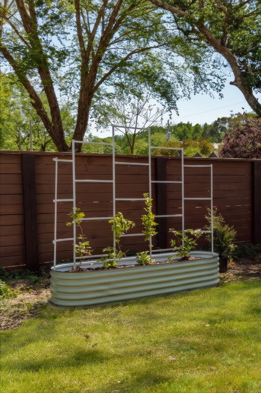 Metal garden bed with plants attached to a metal trellis in front of a wooden fence