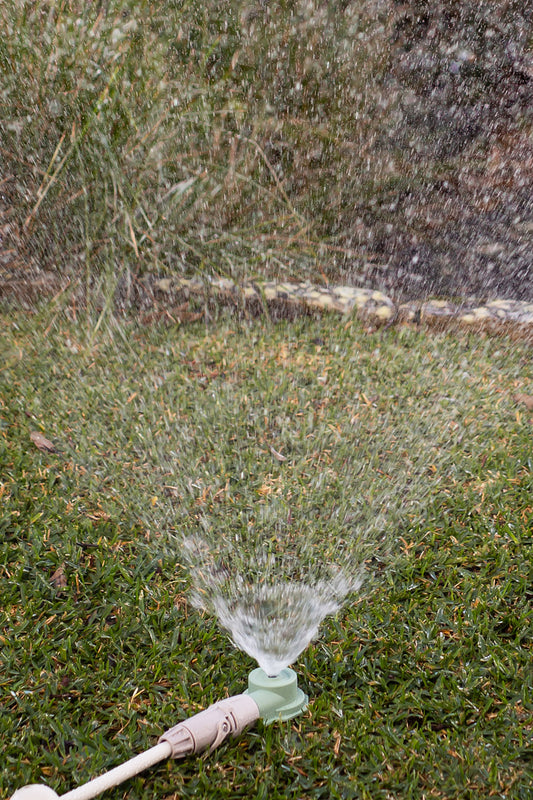 Classic round sprinkler watering lawn