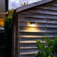 Compact Soalr Flood Light mounted on a brown, wooden weatherboard shed