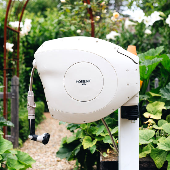 beige retractable hose reel in garden 