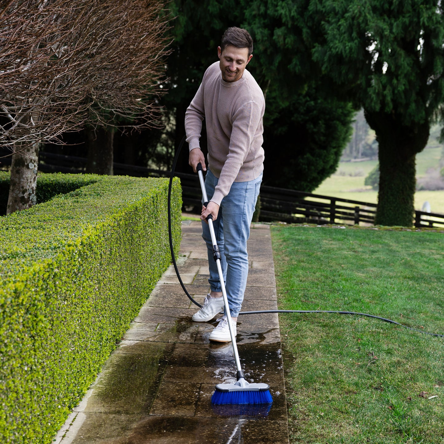 Firm bristle cleaning brush used on path