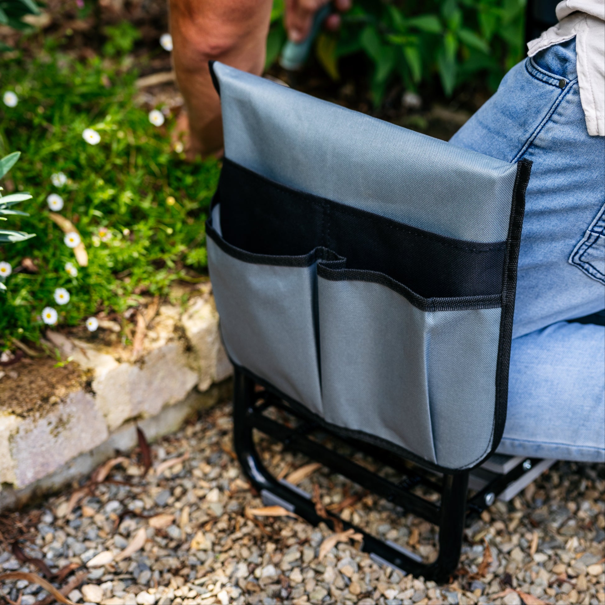 Close up of charcoal and black coloured tool pouch on side of garden kneeler and seat 