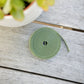 Reusable hook and Loop Plant Tie sitting on a wooden table