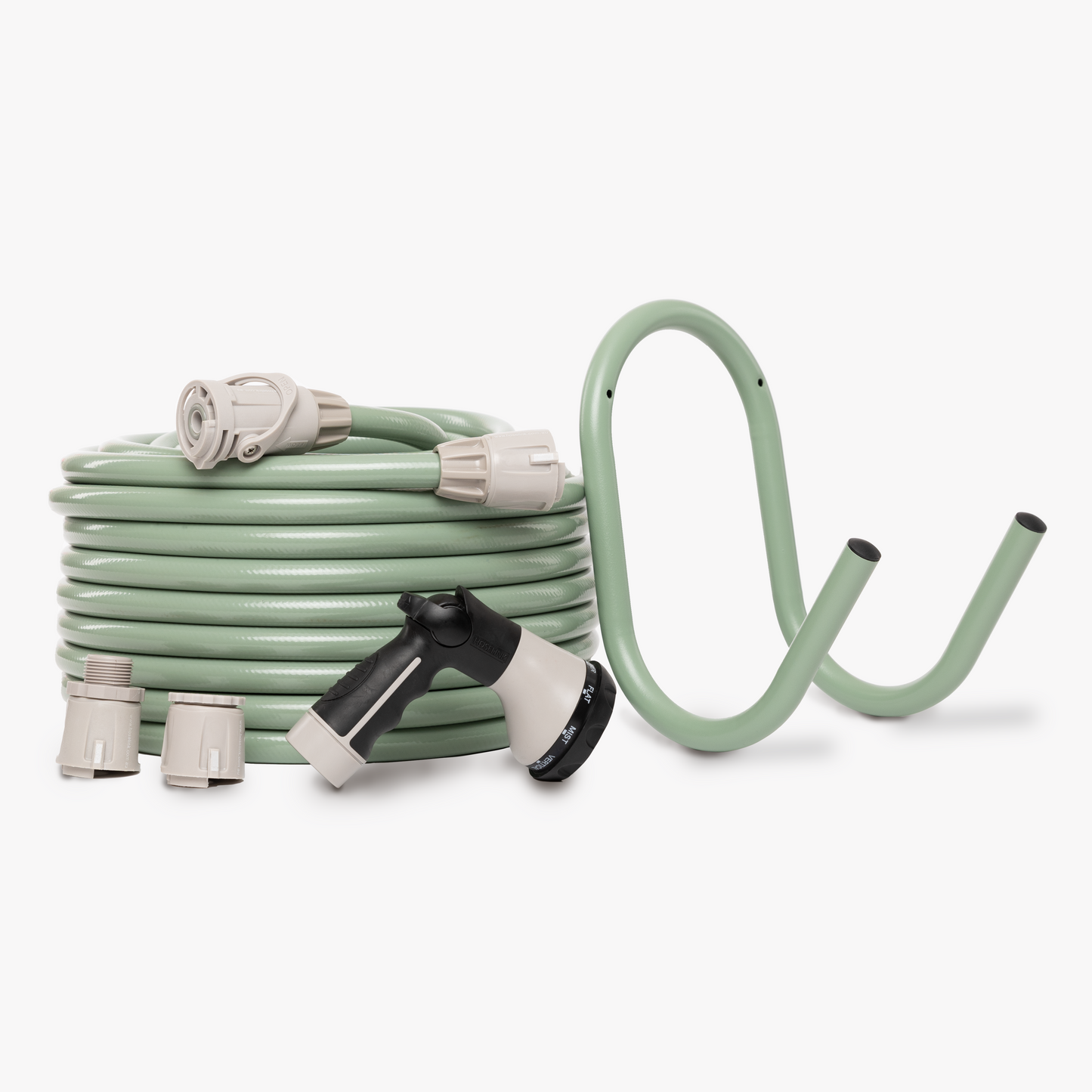 Sage green hose and hanger with grey hose fittings and spray gun on white background