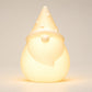 Solar Santa light on a white background, illuminated warm white in colour.