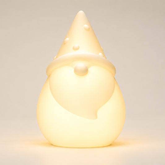 Solar Santa light on a white background, illuminated warm white in colour.