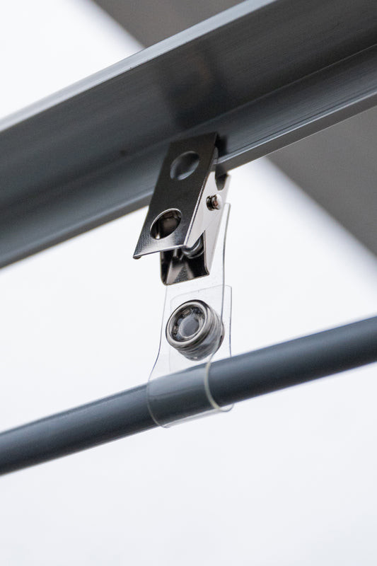 Close-up of misting system installation clip in use in a glass house