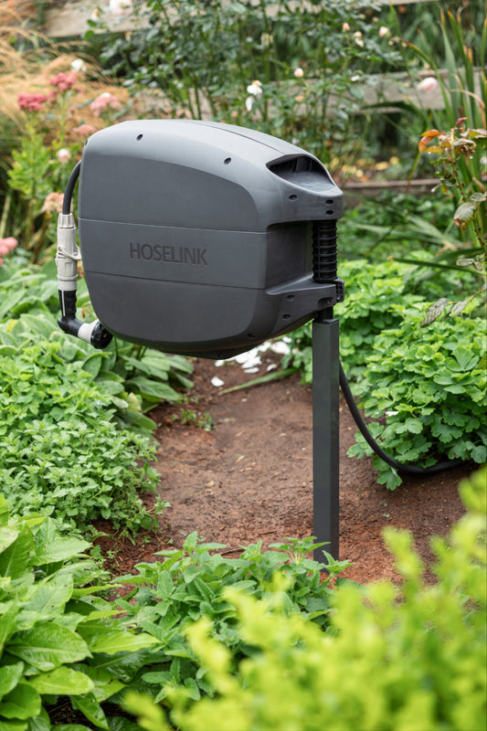 Evolve Mounting Post in lush garden green with a charcoal Evolve hose Reel mounted on it