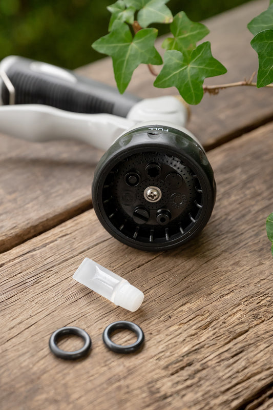 O-rings and lubricant on bench with metal 7-function spray gun