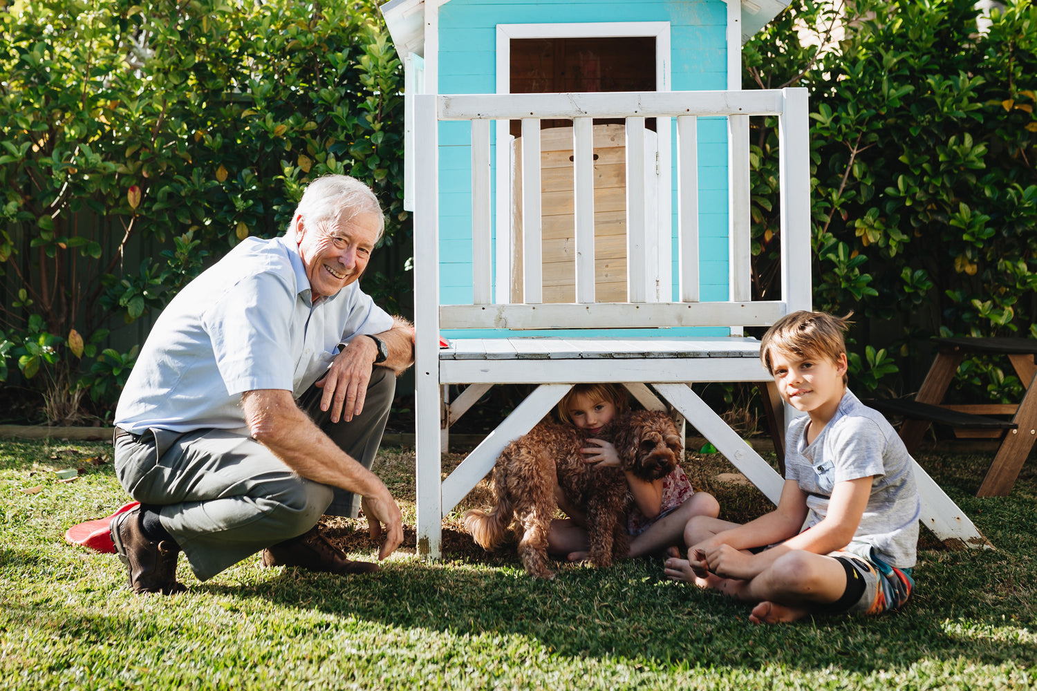 Hoselink founder Tim Kierath with two of his grandchildren and his pet dog enjoying the garden together