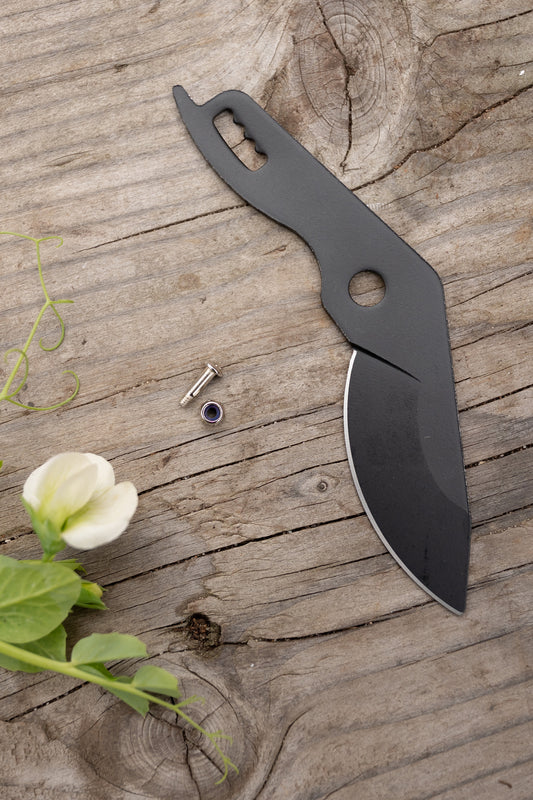 Ratchet Pruners blade and screw and nut set on potting bench with hellebore flower
