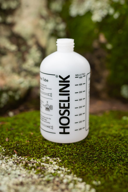 a spare Hoselink fertilizer spray mixer bottle on some moss