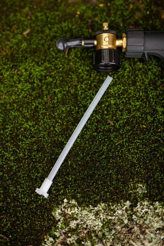 spare siphon tube for fertiliser spray mixer resting on moss