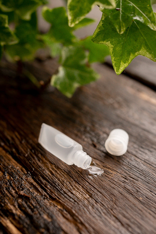 Small tube of lubricant with lid off lying on a table