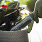 Hori Hori Garden Knife with 'HOSELINK' branding being used on a potted plant.