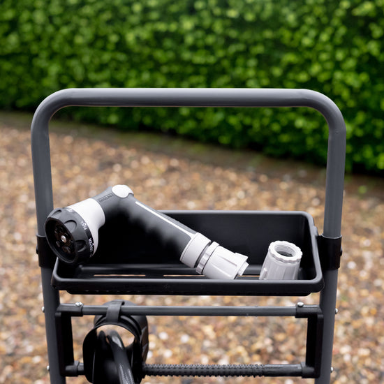 charcoal metal hose reel cart storage shelf up close with sprayer and fitting in it 