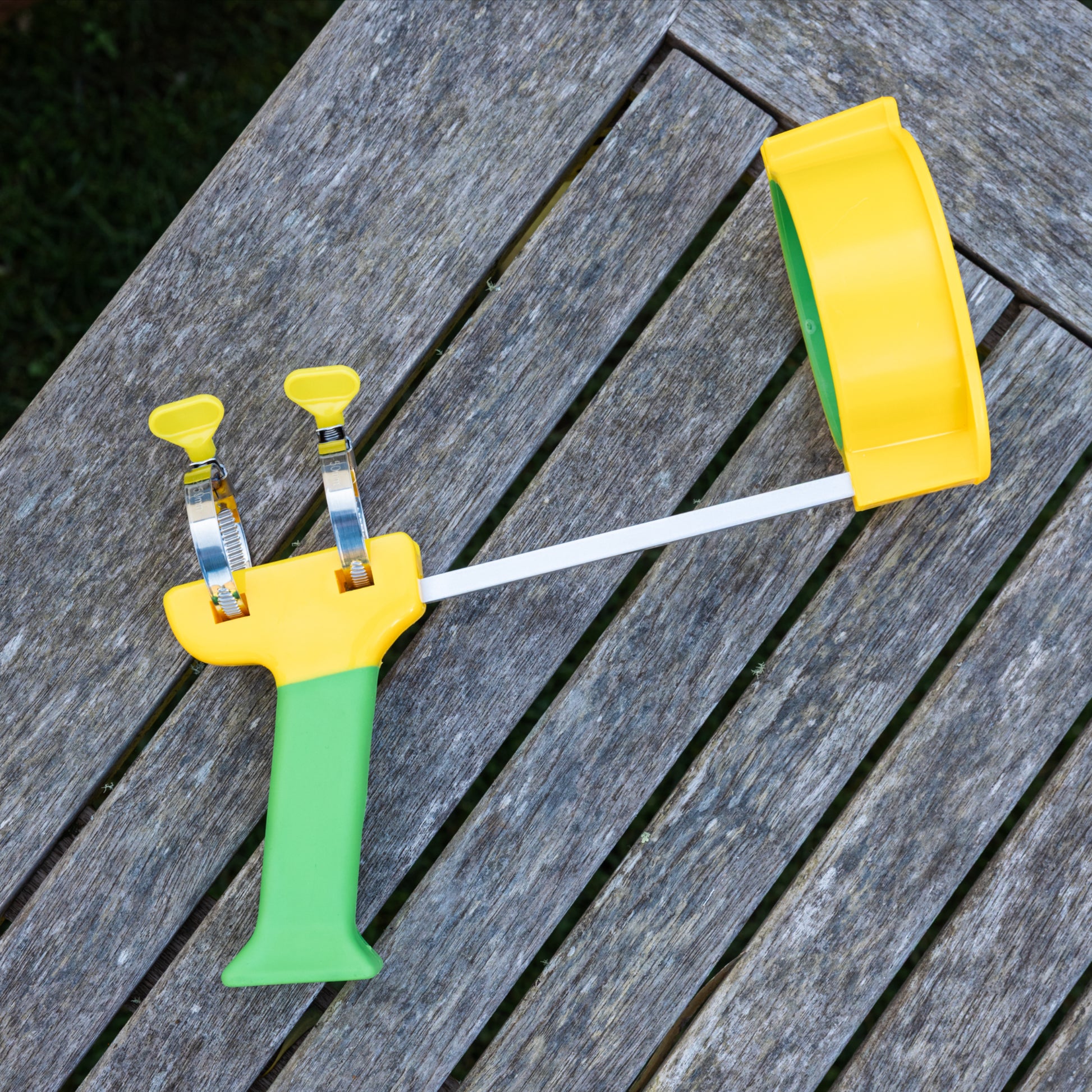 PETA Easi-Grip Arm Support Cuff attached to the PETA Easi-Grip Add-On Handle lying on a wooden deck