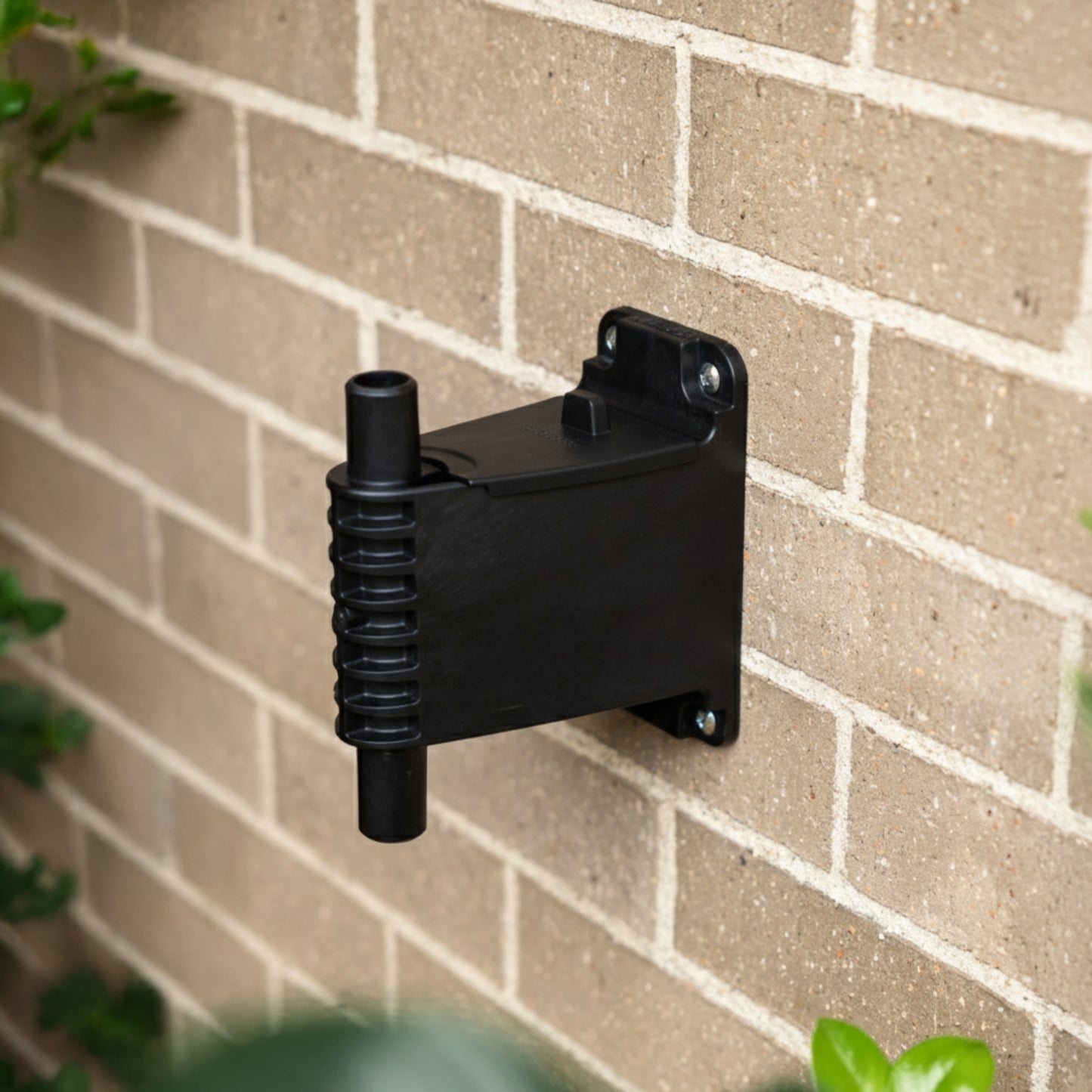 Evolve wall bracket and lid installed on a brown brick wall
