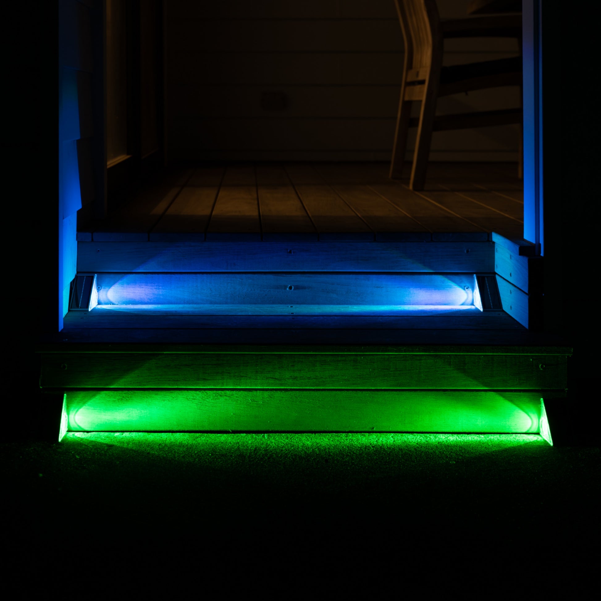 Wooden steps with blue and green LED lights on a dark background