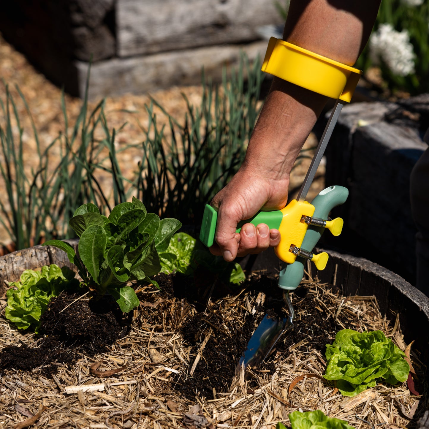 PETA Easi-Grip Arm Support Cuff attached to the PETA Easi-Grip Add-On Handle digging in a pot plant