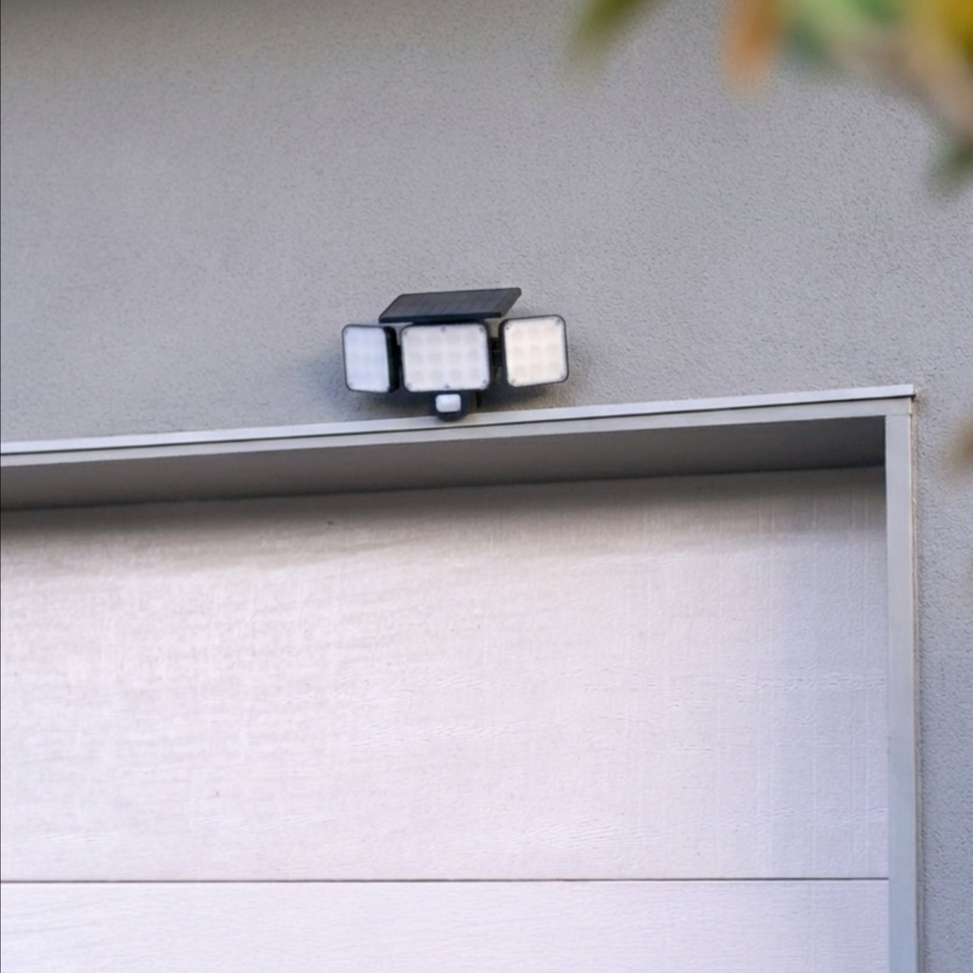 Solar Motion Floodlight above white garage door 