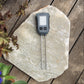 Soil Meter turned on, lying on a piece of slate.