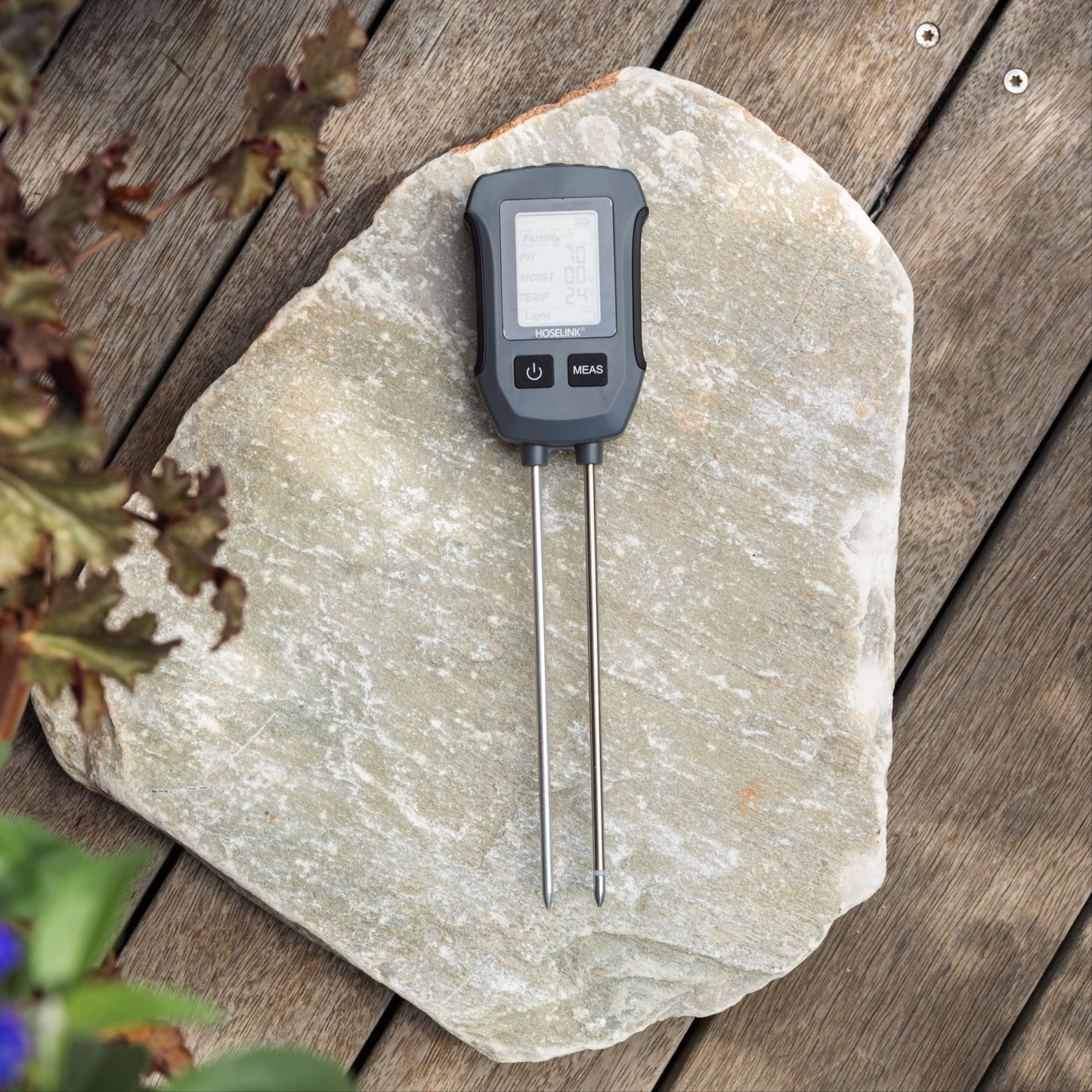 Soil Meter turned on, lying on a piece of slate.