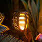 Close-up of Solar Tiki Torch Light surrounded by tropical plants